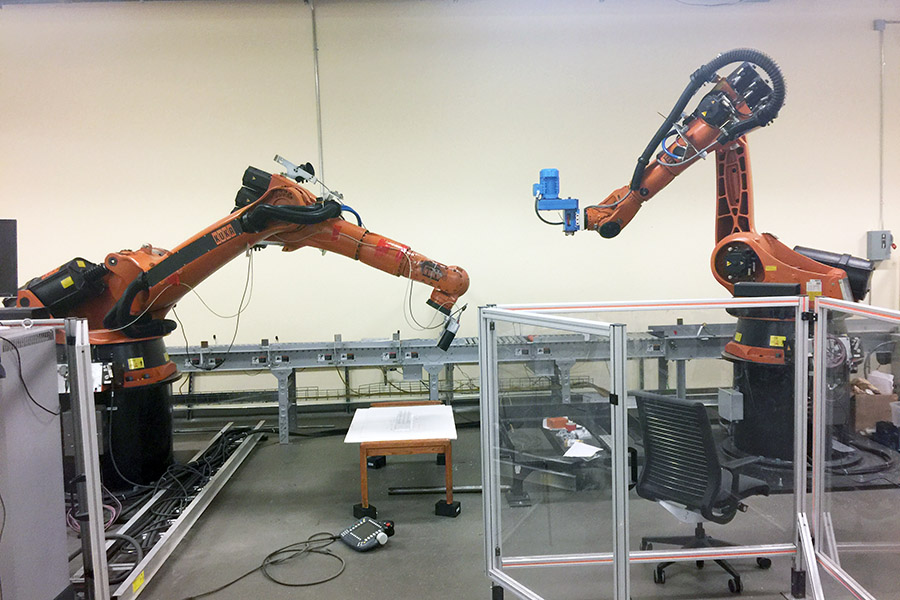 Yong Cho and Jun Ueda will use these two Kuka robotic arms at Georgia Tech’s Institute for Robotics and Intelligent Machines to test a technique where a remote operator uses two excavator arms to accomplish tasks after a disaster at a nuclear power plant, keeping workers away from harmful radiation and unsafe structures. (Photo: Yong Cho)